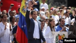 Venezuelan opposition leader and self-proclaimed interim president Juan Guaido waves to supporters during a rally against Venezuelan President Nicolas Maduro's government in Caracas, Venezuela, Feb. 2, 2019.