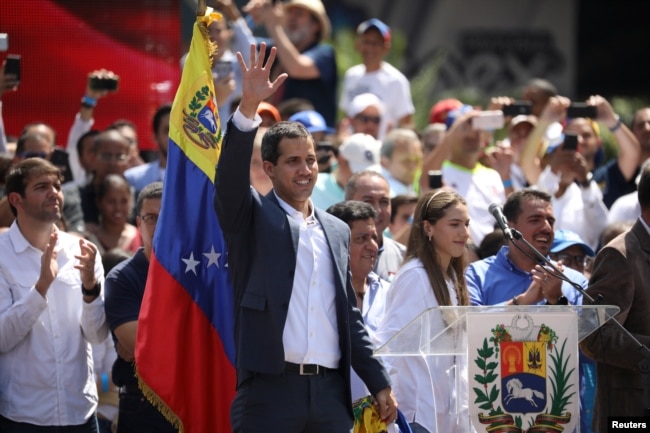 Venezuelan opposition leader and self-proclaimed interim president Juan Guaido waves to supporters during a rally against Venezuelan President Nicolas Maduro's government in Caracas, Venezuela, Feb. 2, 2019.