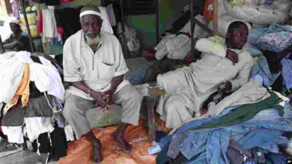 Muslim men sell second hand clothes at Katangua market in Lagos.