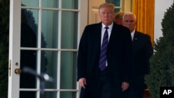 FILE - President Donald Trump walks out of the Oval Office of the White House Jan. 4, 2019, in Washington, as Vice President Mike Pence follows. 