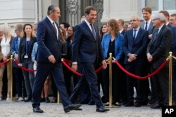 Newly appointed Interior Minister Christophe Castaner, right, and Secretary of State to the Interior Minister Laurent Nunez walk during the handover ceremony at the Interior ministry, in Paris, Oct. 16, 2018.