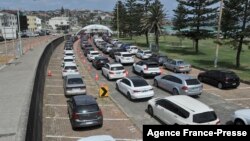 Residents queue up inside their cars for PCR tests at the St Vincent's Bondi Beach COVID-19 drive through testing clinic on Dec. 22, 2021 in Sydney, as the number of COVID-19 cases keeps on the rise across the New South Wales state.