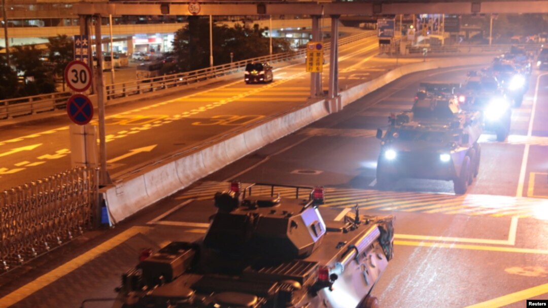 Military vehicles of the Chinese People's Liberation Army (PLA) pass Huanggang Port for a routine troop rotation in Hong Kong, August 29, 2019.