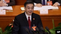 China's Chief Justice Zhou Qiang delivers a speech during a plenary session of the National People's Congress at the Great Hall of the People in Beijing, March 12, 2017. Zhou said Sunday that his country, which is believed to execute more people than the rest of the world combined, gave the death penalty "to an extremely small number of criminals for extremely serious offenses" in the past 10 years.