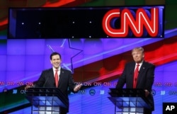 Republican presidential candidate, Sen. Marco Rubio, R-Fla., smiles, as Republican presidential candidate, businessman Donald Trump, grimaces, during the Republican presidential debate, March 10, 2016.