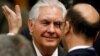 U.S. Secretary of State Rex Tillerson speaks with a delegate during the afternoon ministerial plenary for the Global Coalition working to Defeat ISIS at the State Department in Washington, March 22, 2017. 