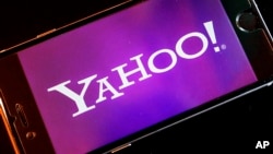 FILE - The Yahoo logo appears on a smartphone.