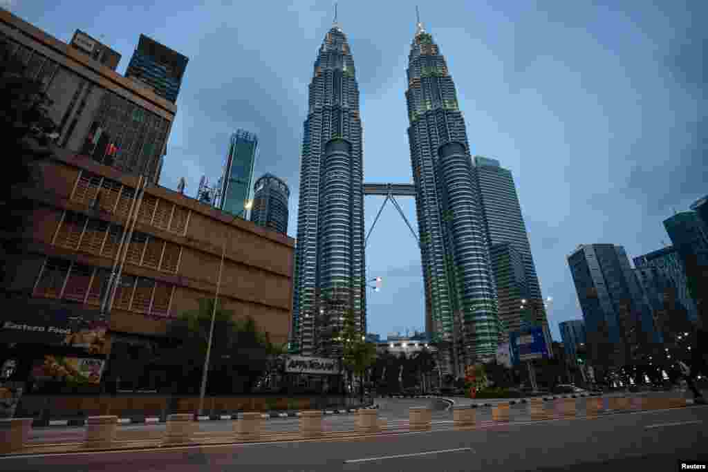 An empty street is seen in front of Petronas Twin Towers after Malaysia&#39;s government announced a movement control order to prevent the spread of the coronavirus, in Kuala Lumpur, Malaysia.