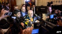 Iranian Foreign Minister Mohammad Javad Zarif, center, speaks to the press after meeting with the German and French foreign ministers in separate meetings at the Beau Rivage Palace Hotel in Lausanne, Switzerland, March 28, 2015. 