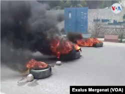 Burning tires block a main road in Gonaïves, Haiti, June 14, 2019.