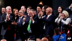 Delegates of Canada, Mexico and the United States celebrate after winning a joint bid to host the 2026 World Cup at the FIFA congress in Moscow, Russia, Wednesday, June 13, 2018. 