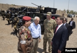 From right, U.S. Defense Secretary Ash Carter and Colonel Otto Liller, commander, 1st Special Forces Group Airborne greet Iraqi Major General Falah al Mohamedawi, left, at the Iraqi Counter Terrorism Service Academy in Baghdad, July 23, 2015.