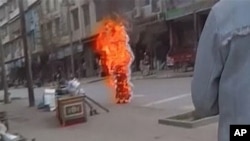 Tibetan Buddhist nun Palden Choetso sets herself ablaze in Chinese-ruled Tibetan autonomous region, Nov. 3, 2011.