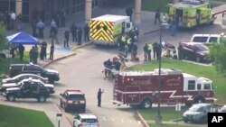 In this image taken from video, emergency personnel and law enforcement officers respond to a high school in Santa Fe, Texas, after an active shooter was reported on campus, May 18, 2018.