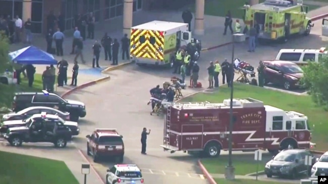 In this image taken from video, emergency personnel and law enforcement officers respond to a high school in Santa Fe, Texas, after an active shooter was reported on campus, May 18, 2018.