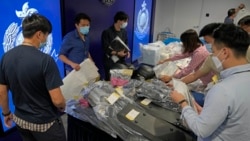 Police officers display seized evidence during a news conference as nine people were arrested over the alleged plot to plant bombs around Hong Kong, at police headquarters in Hong Kong, Tuesday, July 6, 2021. (AP Photo/Kin Cheung)