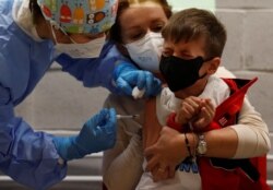 Antonio, 6, receives his first dose of the COVID-19 vaccine at the Explora Children's Museum, as Italy begins vaccinating 5-11 year olds, in Rome, Dec. 16, 2021.