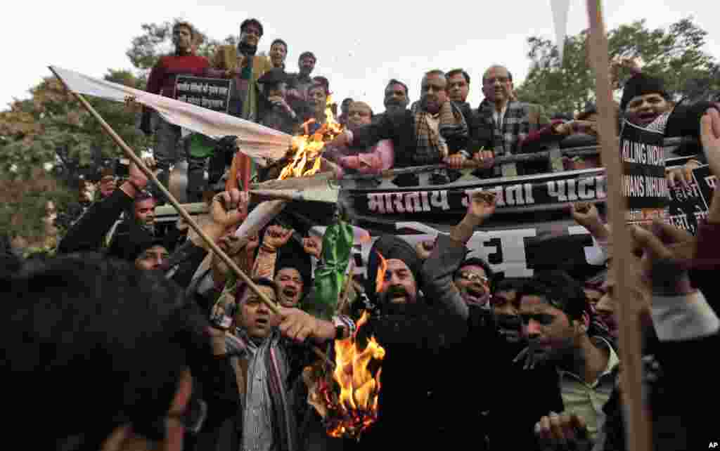 Supporters of India's main opposition BJP set a Pakistani flag on fire during a protest against Pakistan in New Delhi, India, January 9, 2013.