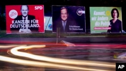Three elections posters show Social Democratic top candidate for chancellor Olaf Scholz, L, Christian Democratic top candidate Armin Laschet, center, and top candidate of the Greens Annalena Baerbock, R, in Frankfurt, Germany, Sept. 15, 2021. 