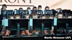 People play the latest video games at the Gamescom computer game fair in Cologne, Germany. 