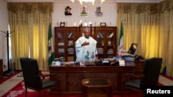 Governor of Borno state Kashim Shettima stands by his desk in the state house in Maiduguri May 22, 2014.