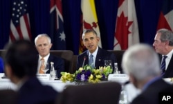 FILE - President Barack Obama, center, sitting next to Australia’s Prime Minister Malcolm Turnbull, left, and U.S. Trade Representative Michael Froman, right, speaks during a meeting with other leaders of the Trans-Pacific Partnership countries in Manila, Philippines, Nov. 18, 2015, ahead of an Asia-Pacific Economic Cooperation summit.