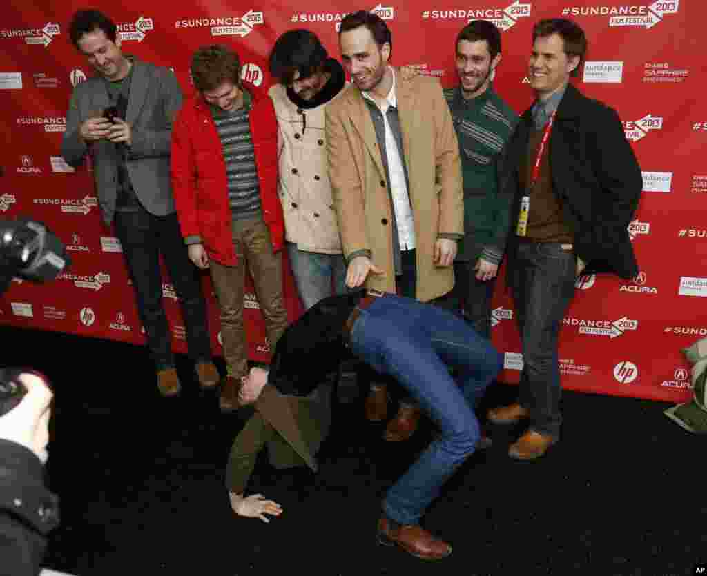 Cast member Gaby Hoffmann leans over backwards in front of other including actor Michael Cera, second left, and director Sebastian Silva, third right, at the premiere of "Crystal Fairy" during the 2013 Sundance Film Festival, January 17, 2013.