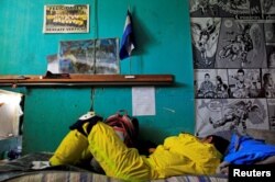 A rescue worker sleeps after the night shift at the Comandos de Salvamento (Rescue Corps) base in San Salvador, El Salvador, July 2, 2016.
