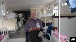 FILE - Albino Said Abdallah, who lost his left hand in an attack, is seen recovering at Morogoro hospital, Tanzania, May 7, 2010.
