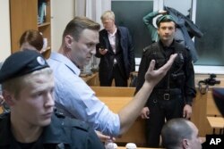 FILE - Russian opposition leader Alexei Navalny gestures while speaking in a court room in Moscow, Russia, Oct. 2, 2017. Navalny is currently serving a 20-day jail term for organizing an unsanctioned protest.