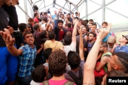 Migrants gather at the railway station in the town of Bicske, Hungary, Sept. 3, 2015.