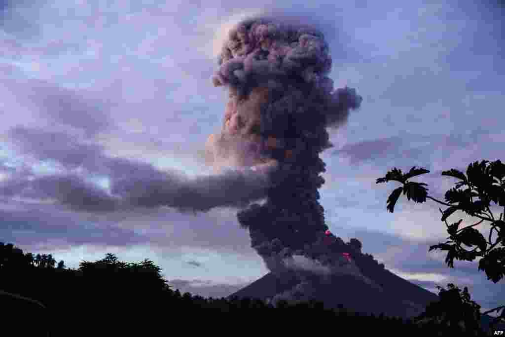 The Mayon volcano spews lava as it continues to erupt, as seen from Daraga town, in Albay province, south of Manila, Philippines.