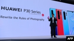 FILE - Chinese Telecom equipment company Huawei Consumer Products division CEO Richard Yu gestures as he speaks on stage during the presentation the new P30 smart-phone, in Paris, on March 26, 2019. 