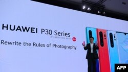 Chinese Telecom equipment company Huawei Consumer Products division CEO Richard Yu gestures as he speaks on stage during the presentation the new P30 smart-phone, in Paris, on March 26, 2019. (Photo by ERIC PIERMONT / AFP)