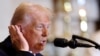 U.S. President Donald Trump motions toward the ear that was injured in an assassination attempt as he speaks during the annual National Prayer Breakfast at the U.S. Capitol in Washington on Feb. 6, 2025. 