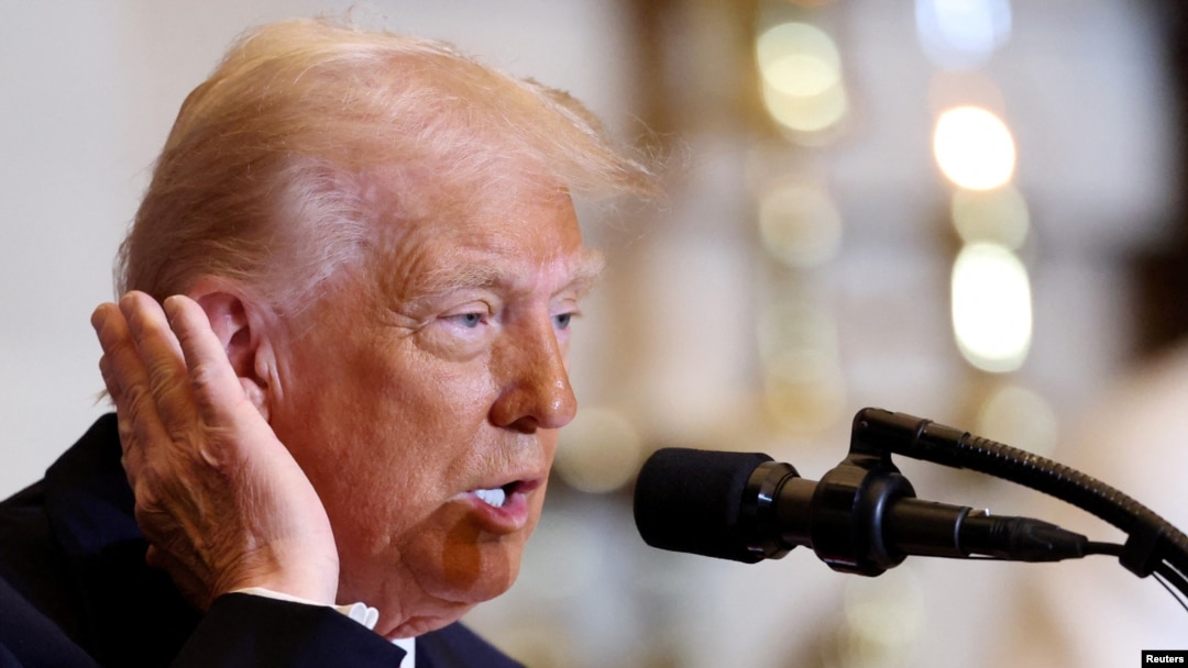 U.S. President Donald Trump motions toward the ear that was injured in an assassination attempt as he speaks during the annual National Prayer Breakfast at the U.S. Capitol in Washington on Feb. 6, 2025. 