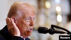 U.S. President Donald Trump motions toward the ear that was injured in an assassination attempt as he speaks during the annual National Prayer Breakfast at the U.S. Capitol in Washington on Feb. 6, 2025. 