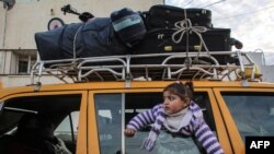 A girl looks out of the window of a vehicle while waiting at the Rafah border crossing&#39;s departure area to travel from the Gaza Strip into Egypt, which reopened after Egypt announced to let through incoming traffic until further notice.&nbsp;