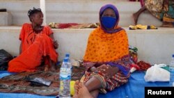 FILE - Displaced women sit on mats after fleeing an attack claimed by Islamic State-linked insurgents on the town of Palma, at a displacement centre in Pemba, Mozambique, April 2, 2021.