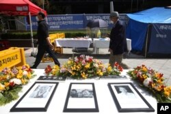 Portraits of the late former South Korean comfort women are displayed near Japanese Embassy in Seoul, South Korea, April 21, 2021.
