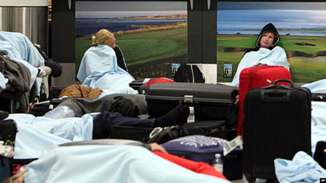 Passengers rest on the floor as their flights have been canceled at Edinburgh Airport in Edinburgh, Scotland, May 24, 2011