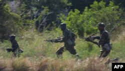 FILE - Kenyan soldiers participate in a joint military exercise with US Marines near the coastal town of Lamu in this Jan. 15, 2004 photo. 