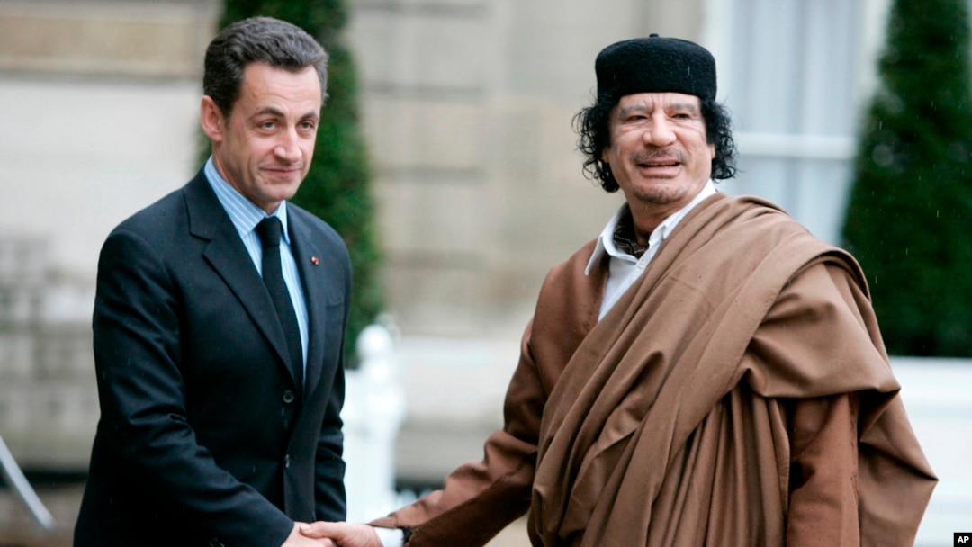 FILE - French President Nicolas Sarkozy, left, greets Libyan leader Col. Moammar Gadhafi upon his arrival at the Elysee Palace, Dec. 10, 2007 in Paris.