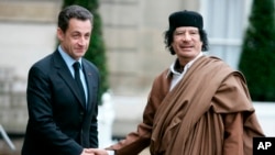 FILE - French President Nicolas Sarkozy, left, greets Libyan leader Col. Moammar Gadhafi upon his arrival at the Elysee Palace, Dec. 10, 2007 in Paris.