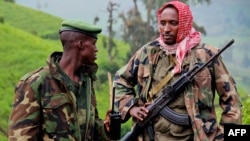 A picture taken on June 3, 2012 shows rebels of the mutinous armed force known as M23 patrolling on the hill of Kavumu in North Kivu, Democratic Republic of the Congo (DRC).