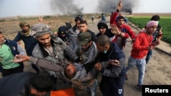 A wounded Palestinian demonstrator is evacuated during clashes with Israeli troops at a protest against U.S. President Donald Trump's decision to recognize Jerusalem as the capital of Israel, near the border with Israel in the southern Gaza Strip, Dec. 29, 2017.