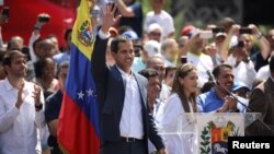 Venezuelan opposition leader and self-proclaimed interim president Juan Guaido waves to supporters during a rally against Venezuelan President Nicolas Maduro's government in Caracas, Venezuela, Feb. 2, 2019.