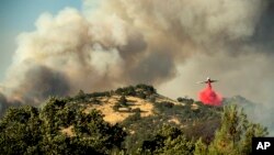 An air tanker drops retardant on a wildfire above the Spring Lakes community, June 24, 2018., near Clearlake Oaks, California. 