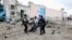 Somali government soldiers evacuate an injured man after a suicide bomb attack at a U.N. compound in Mogadishu, June 19, 2013. 