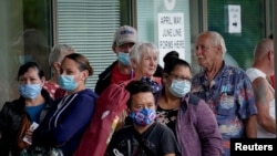 FILE - People line up outside a Kentucky Career Center hoping to find assistance with their unemployment claim in Frankfort, Kentucky, June 18, 2020. 